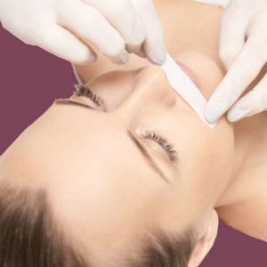 Woman getting her mustache area waxed
